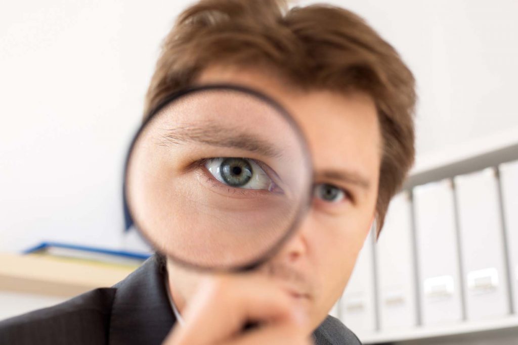 man with magnifying glass