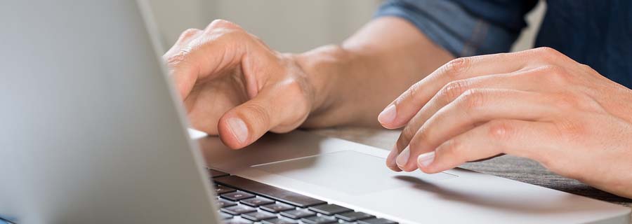 Closeup hand of businessman using laptop at office. 