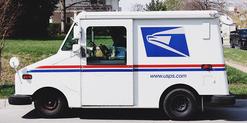 us postal service truck on a street