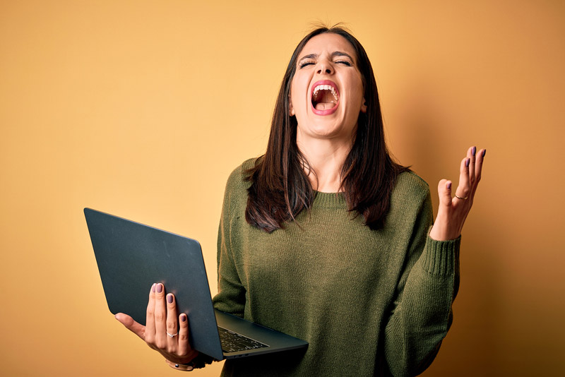 Screaming woman with laptop